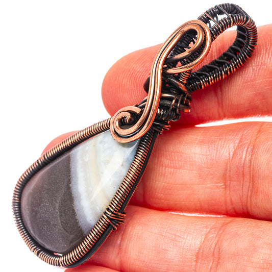 Oxidized copper wire-wrapped teardrop banded agate pendant detail, loop frame