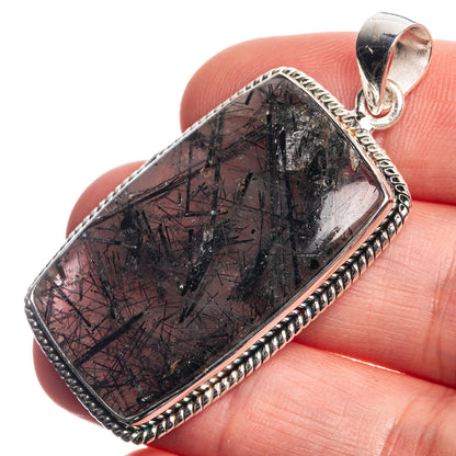 Sterling silver pendant with dark tourmalinated quartz cabochon and rope bezel