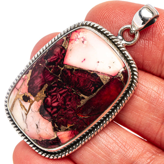 Oval sterling silver pendant with rope-edge bezel and pink, red, gold inlay stone