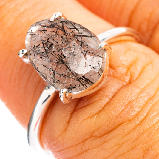 Sterling silver ring on hand, faceted quartz with black tourmaline needle pattern