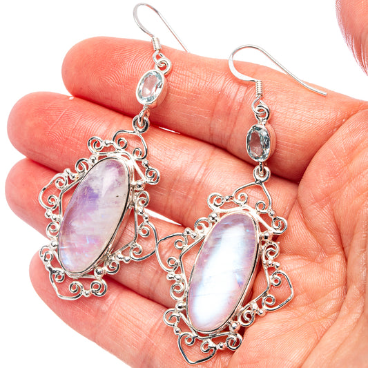 Sterling silver drop earrings with iridescent pink-white oval stones and blue accent