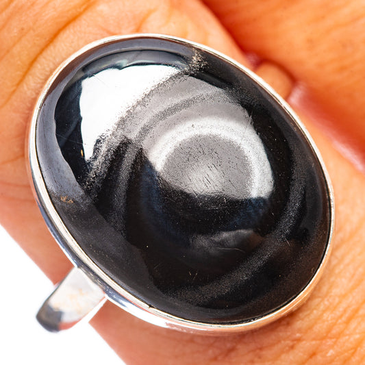 Sterling silver ring with oval dark psilomelane stone bezel, close-up top view
