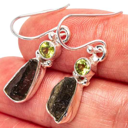 925 sterling silver earrings close-up with round green stones and dark raw teardrop dangles