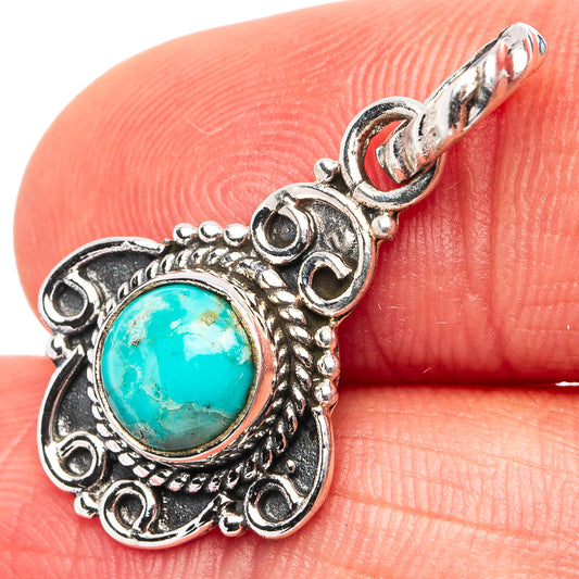 Turquoise oval pendant in .925 sterling silver with ornate circular border