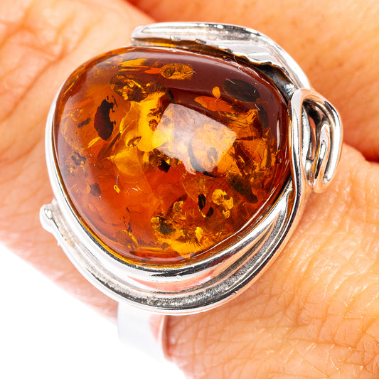Oval amber cabochon ring in .925 sterling silver bezel, dark honey flecked