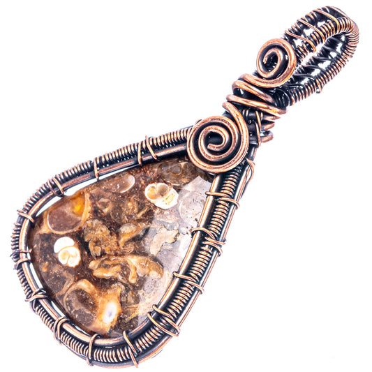 Oxidized copper teardrop agate pendant with coiled wire loops and fossil-like white marks