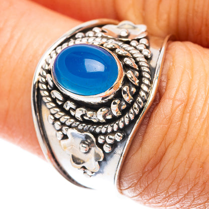 Sterling silver ring with oval blue gemstone cabochon and ornate filigree setting