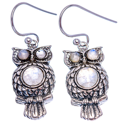Pair of silver owl drop earrings with moonstone opalescent center and wing stones, hooks.