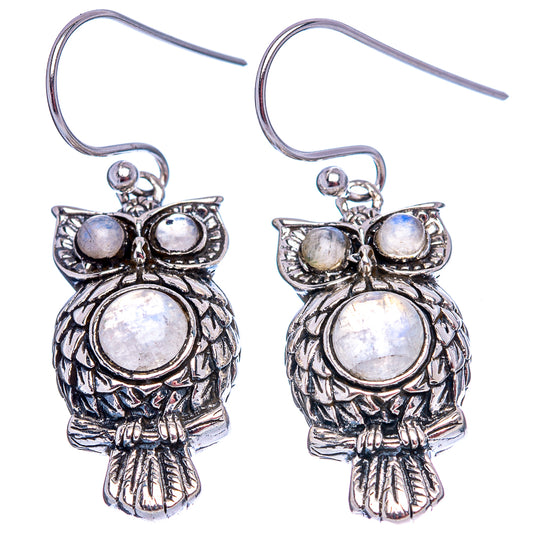 Pair of silver owl drop earrings with moonstone opalescent center and wing stones, hooks.