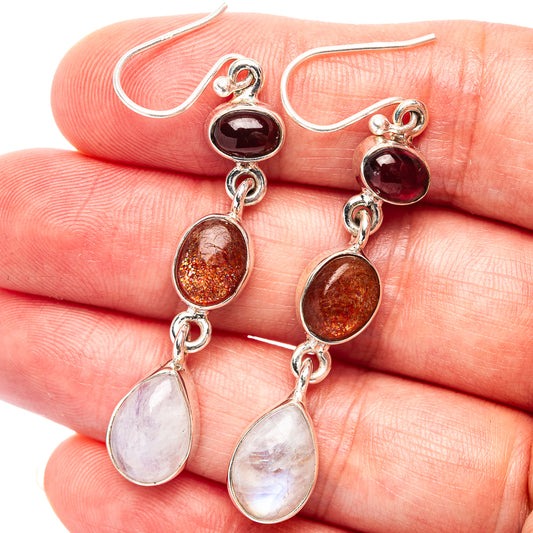 Sterling silver drop earrings with dark red and golden orange gemstones and pear-shaped moonstone drops