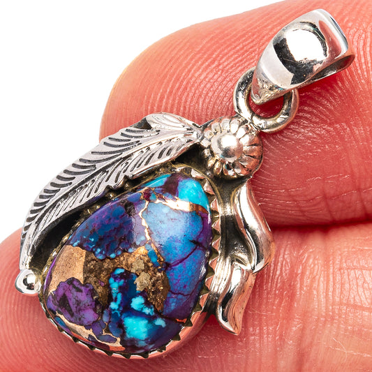 Sterling silver turquoise pendant close-up with purple-blue teardrop stone and leaf accents