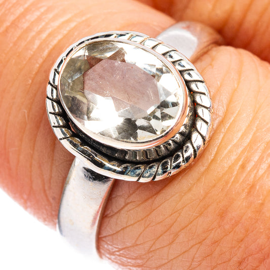 Sterling silver ring with faceted oval gemstone and ornate bezel setting