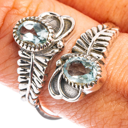 Adjustable sterling silver ring with two faceted blue topaz stones, close-up