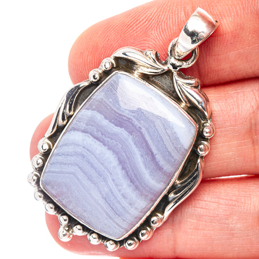 Sterling silver lace agate pendant with rectangular blue stone in beaded ornate setting