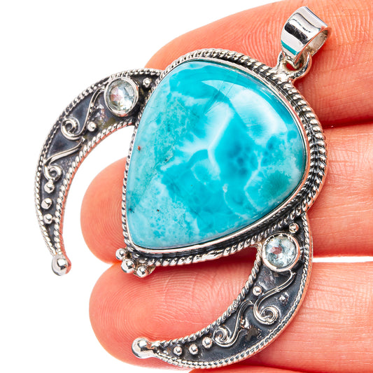 Sterling silver pendant with large oval turquoise Larimar-style stone and blue topaz side stones