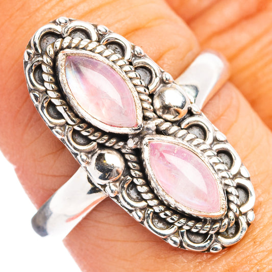 Silver ring with two pink oval moonstone-style gems and ornate rope-like bezel setting