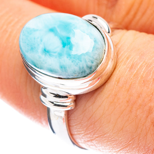 Sterling silver ring with oval turquoise larimar center and twisting band