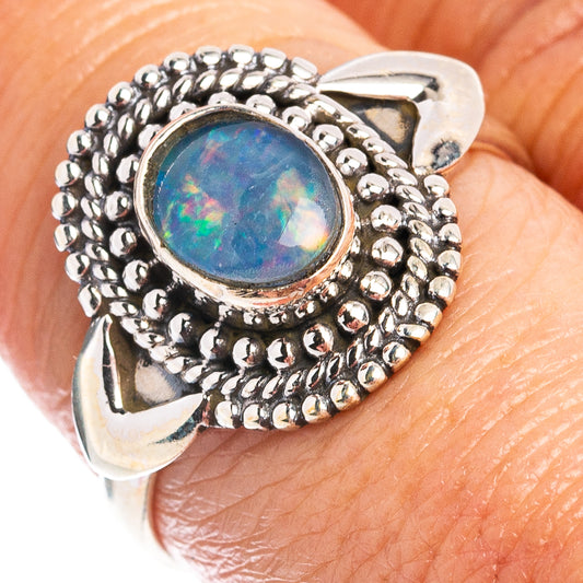Sterling silver opal ring with oval blue-green stone and beaded triple halo