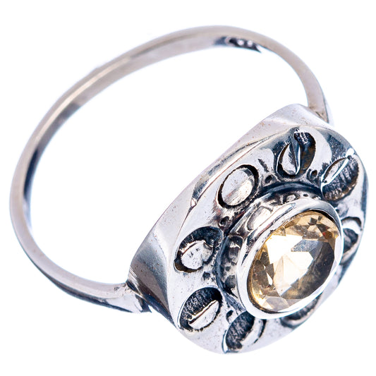 Sterling silver ring with round yellow gemstone set in engraved bezel