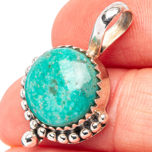 Turquoise oval pendant with silver bail and beaded rope frame