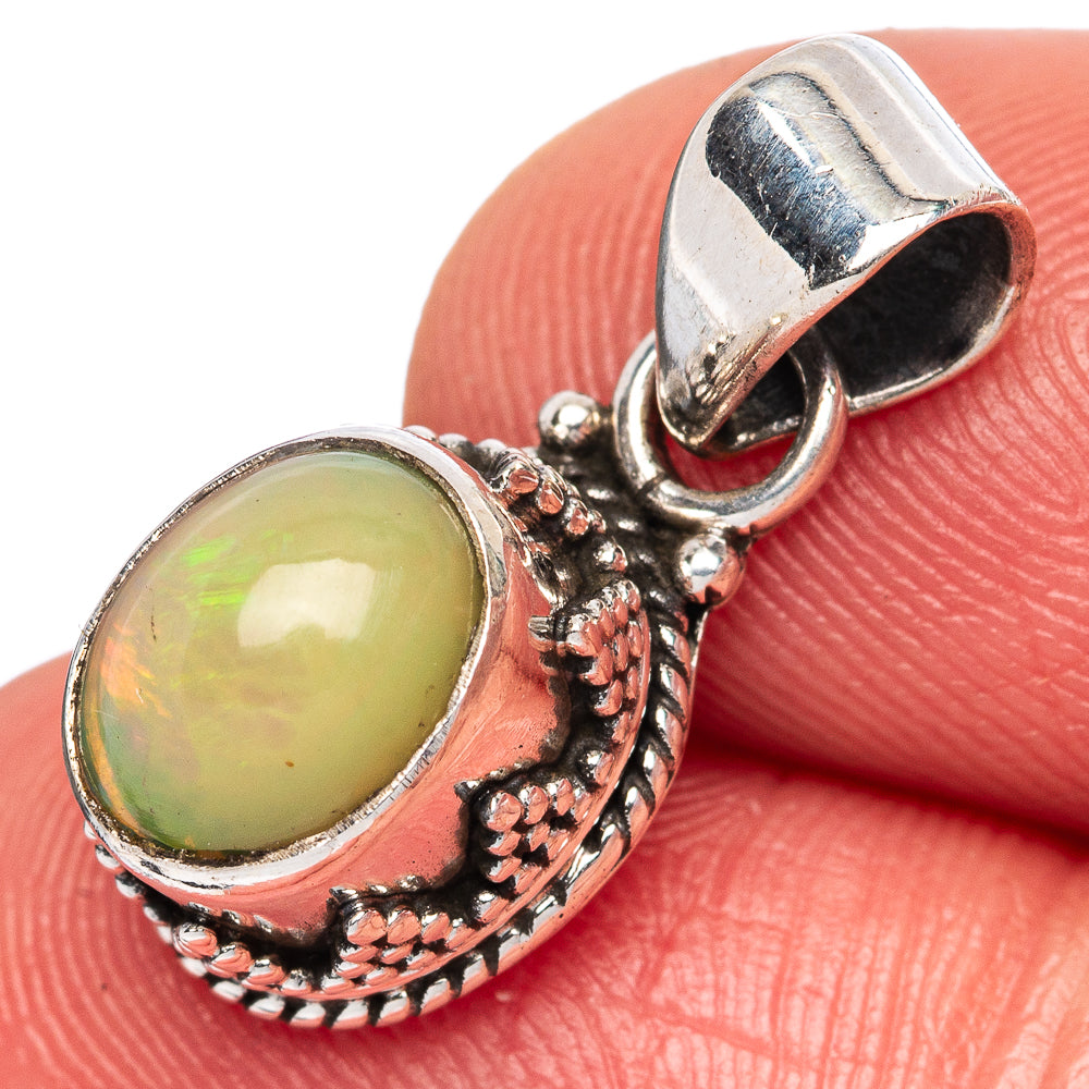 Ethiopian opal pendant in oval bezel, yellow-green stone with ornate silver bail