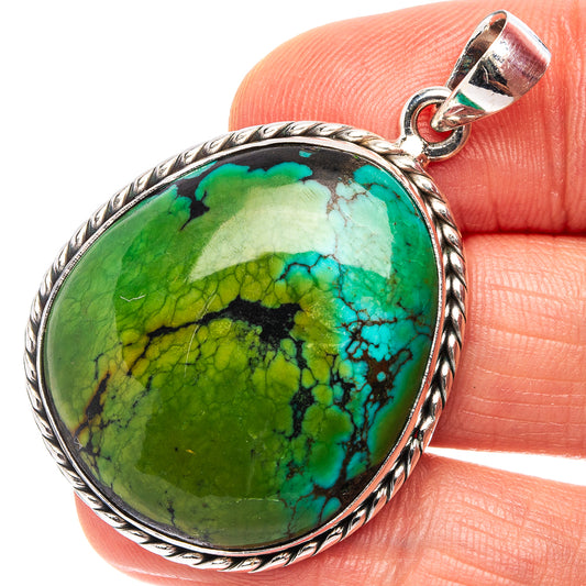 Turquoise pendant with oval silver setting and bail, green-blue stone