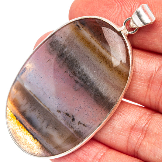 Silver-plated oval agate pendant with dark gray and gold banding, top bail