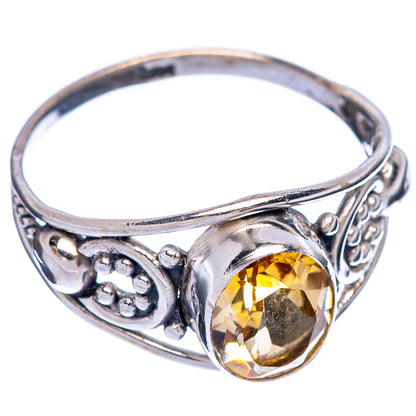 Sterling silver ring with faceted oval citrine center stone and decorative side scrollwork