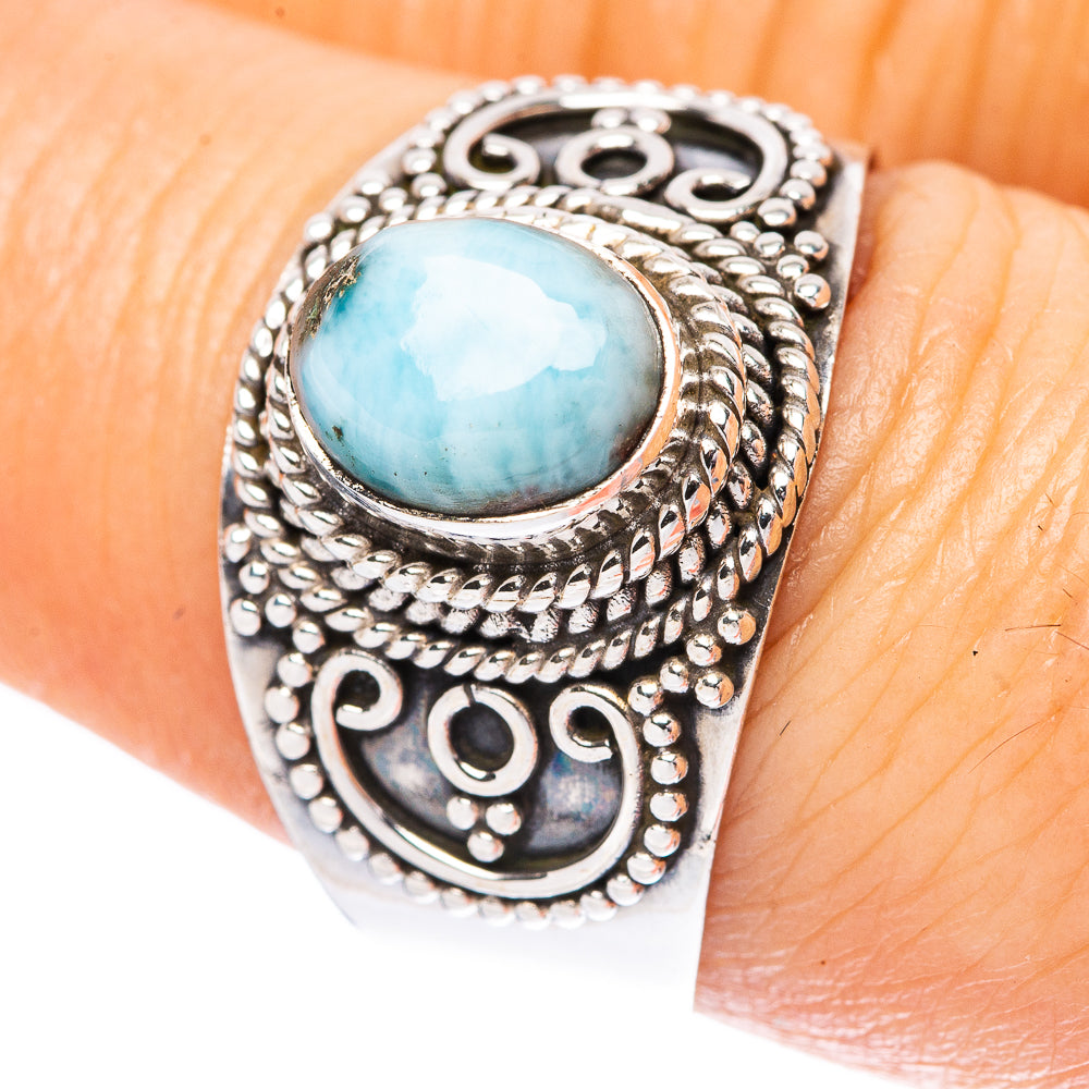 Sterling silver ring with oval light-blue larimar cabochon and ornate engraved band