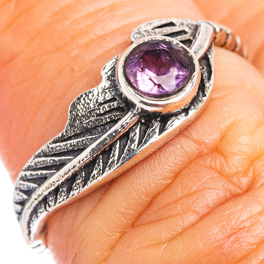 Sterling silver feather ring close-up with purple amethyst oval gemstone
