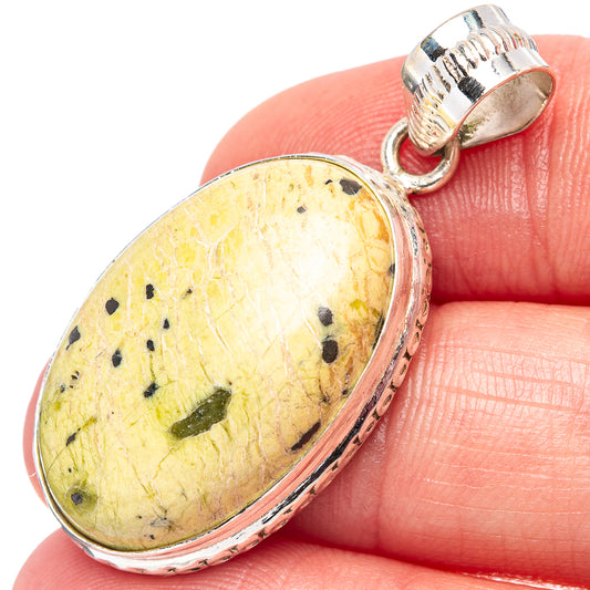 Atlantisite sterling silver pendant with oval yellow stone and black speckles, bail top