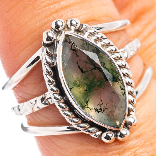 Sterling silver ring showing large green moss agate cabochon with braided bezel and side beads