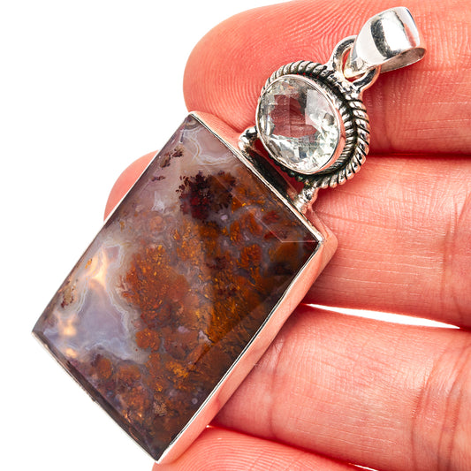 Sterling silver pendant with rectangular brown plume agate and clear oval stone