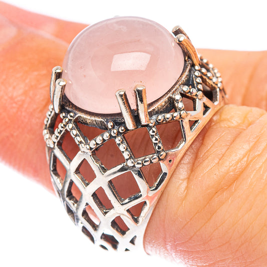 Rose quartz oval cabochon in silver filigree bezel, lattice cutout band