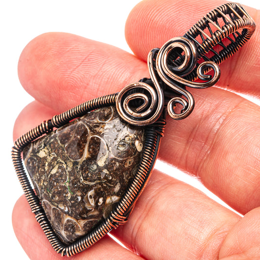 Oxidized copper wire-wrapped teardrop agate pendant detail, spiral wraps and stone facets