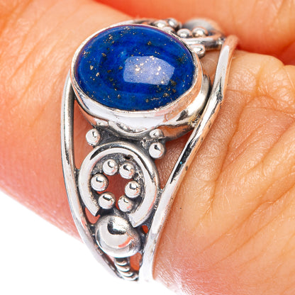 Sterling silver ring with oval blue lapis lazuli cabochon and ornate cutout side details