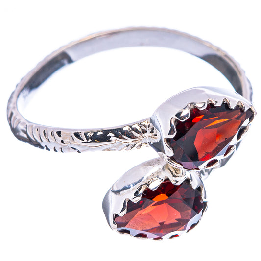 Sterling silver ring with two faceted red stones and ornate band scrollwork