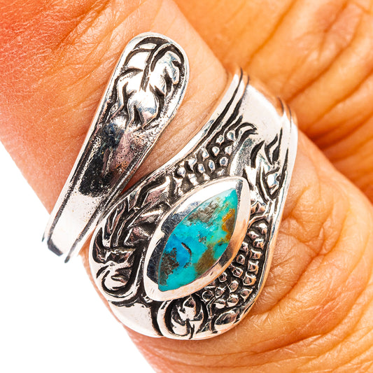 Turquoise oval sterling silver ring with engraved western design, adjustable band.