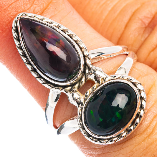 Sterling silver statement ring with two oval opal stones on an open, ornate band
