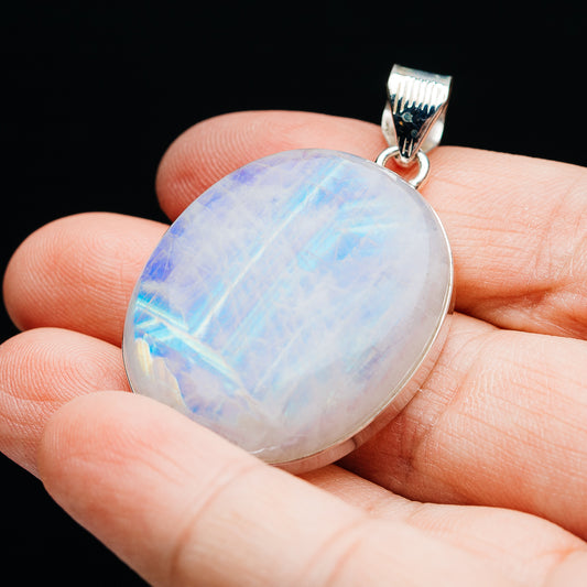 Sterling silver rainbow moonstone pendant with oval stone and top bail, close-up