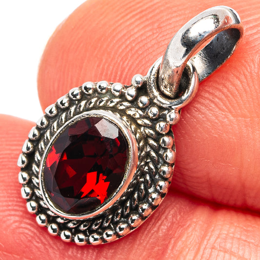 Sterling silver garnet pendant with oval red gemstone and scalloped halo frame