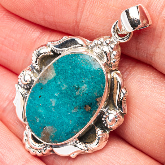 Oval turquoise pendant in detailed .925 sterling silver bezel, with bail at top.