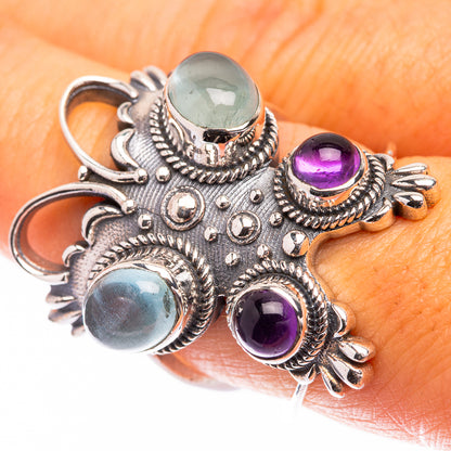 Ornate sterling silver ring with aquamarine and amethyst cabochon gemstones
