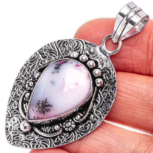 Ornate silver-tone pendant with pink dendritic opal teardrop stone and bail