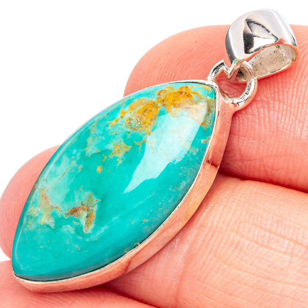 Oval turquoise stone pendant in sterling silver bezel on clasp ring