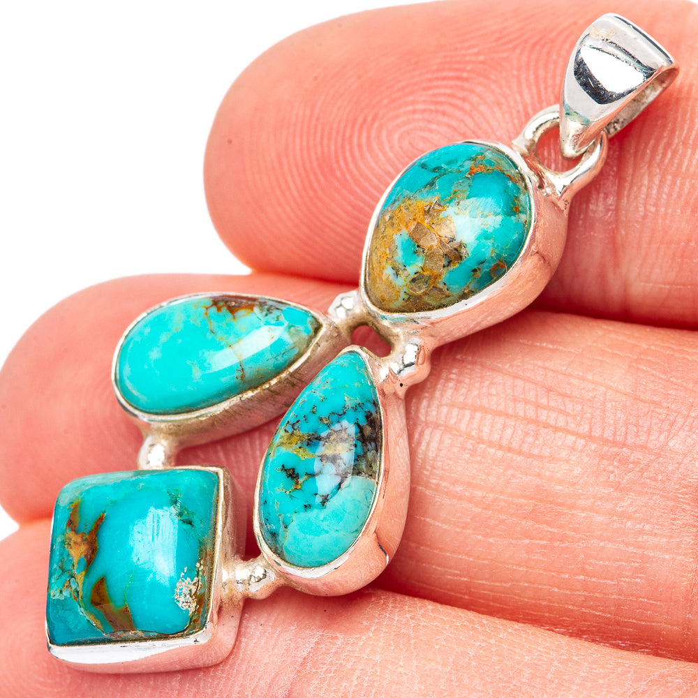 Sterling silver turquoise pendant with five cabochon stones and a round bail, close-up