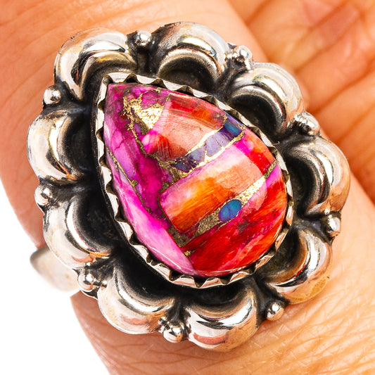 Sterling silver oval gemstone ring with ornate swirl setting, vibrant pink orange inlay