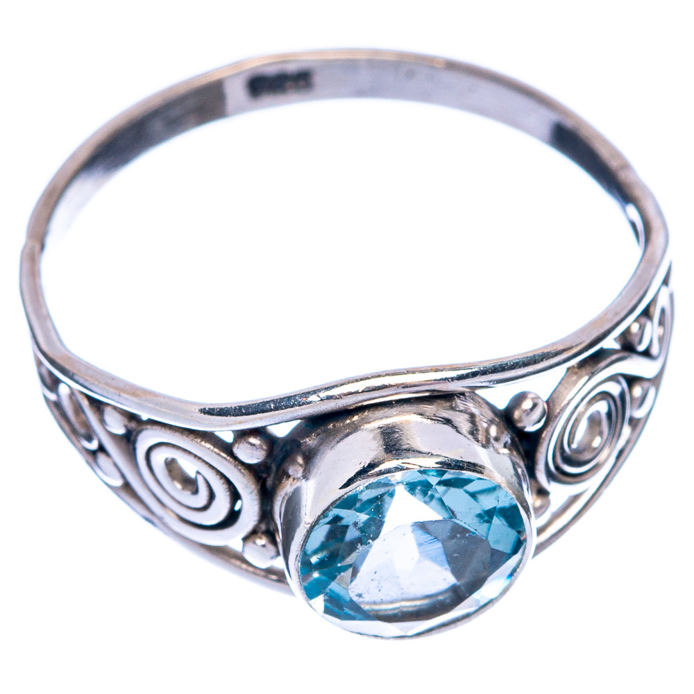 Sterling silver ring with round blue topaz center and engraved scrolling band