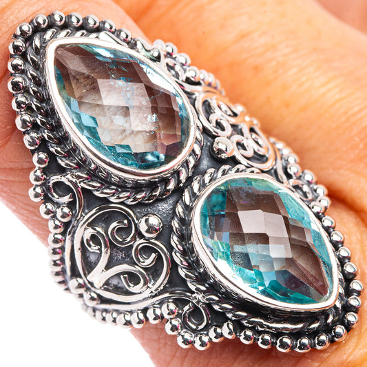 Sterling silver ring with two oval blue topaz stones and ornate scrollwork