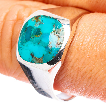 Sterling silver turquoise cabochon ring with oval stone, close-up on finger